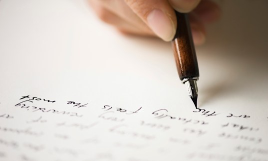 person writing a letter